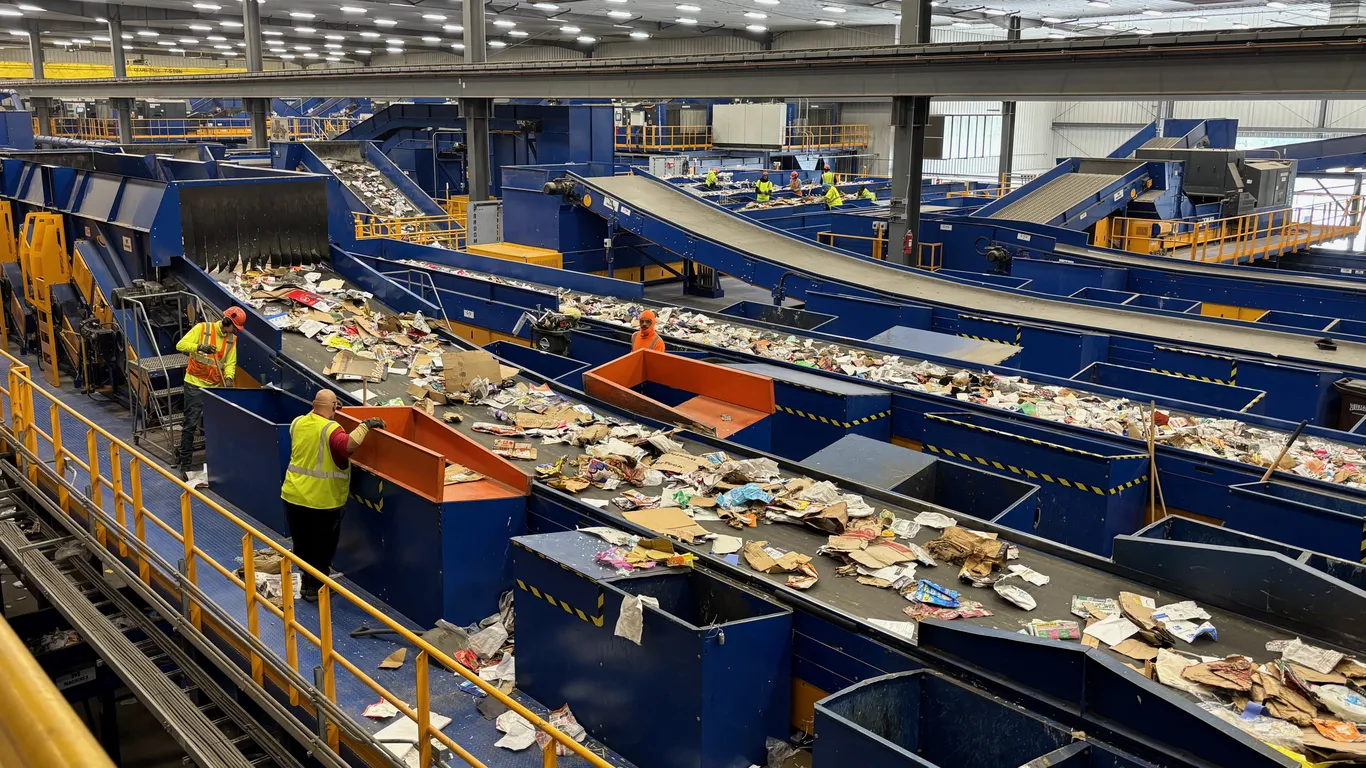 Workers sorting material on an industrial recovery line